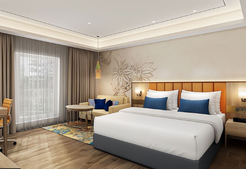 a large bed with white linens and blue accent pillows is in a room with wooden floors at Ekante Bliss Tirupati - Ihcl SeleQtions