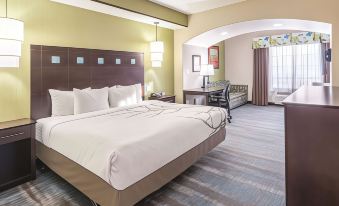 a hotel room with two beds , one on the left side of the room and the other on the right side at La Quinta Inn & Suites by Wyndham Dallas Grand Prairie South