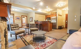 a spacious living room with various furniture , including a couch , chairs , and a dining table at The Village at Palisades Tahoe
