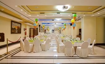 a large dining room with tables and chairs set up for a party or event at Semeli Hotel