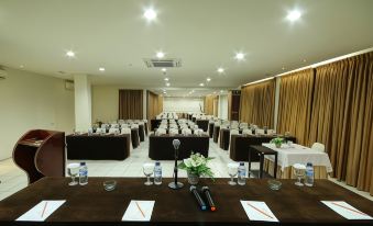a large conference room with rows of tables and chairs , ready for a meeting or event at The Pade Hotel