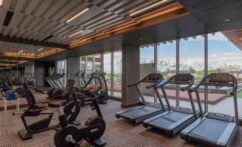 a well - equipped gym with various exercise equipment , such as treadmills , weight machines , and stationary bikes at Neelkanth Sarovar Premiere