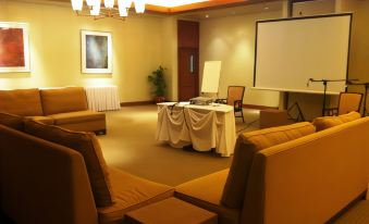 a conference room with several chairs arranged in rows and a whiteboard on the wall at Timberland Highlands Resort