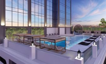 A rendering depicts the exterior view of an apartment complex, featuring spacious windows and a swimming pool at Aira Hotel Bangkok Sukhumvit 11
