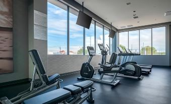 a well - equipped gym with various exercise equipment , such as treadmills , stationary bikes , and weight machines at Courtyard Ciudad Juarez