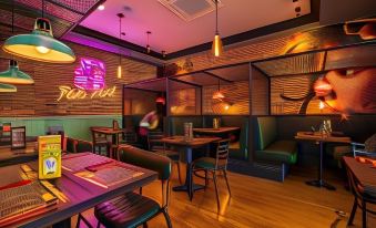 a modern restaurant with wooden floors , exposed brick walls , and neon lights , featuring multiple dining tables and chairs at Ibis London Greenwich