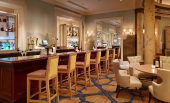 a modern bar with wooden furniture , blue and white flooring , and a large mirror above the counter at Country Inn & Suites by Radisson, Baltimore North/White Marsh