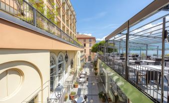 a view of a building with a large glass enclosure and an outdoor seating area at Hotel Bazzoni
