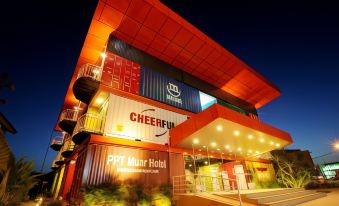 a large building made out of shipping containers , located in a city at night at Ppt Muar Hotel