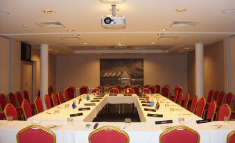 a large conference room with a long table and numerous chairs arranged for a meeting at Te Moana Tahiti Resort