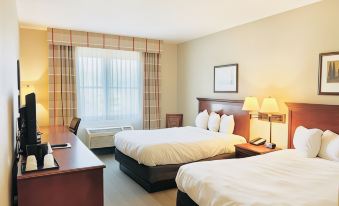 a hotel room with two beds , nightstands , and lamps , as well as a desk and window at Country Inn & Suites by Radisson, Emporia, VA