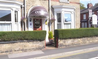 "a brick building with a brown awning and the words "" cumbria "" written above it on it" at Diamonds Villa Near York Hospital