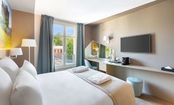 a hotel room with a king - sized bed , a flat - screen tv mounted on the wall , and a window overlooking a balcony at Best Western le Beffroi