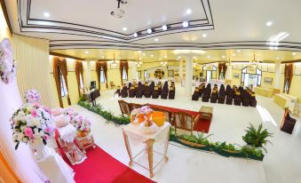 a large , well - decorated banquet hall with multiple tables and chairs set up for a formal event at Lampam Resort