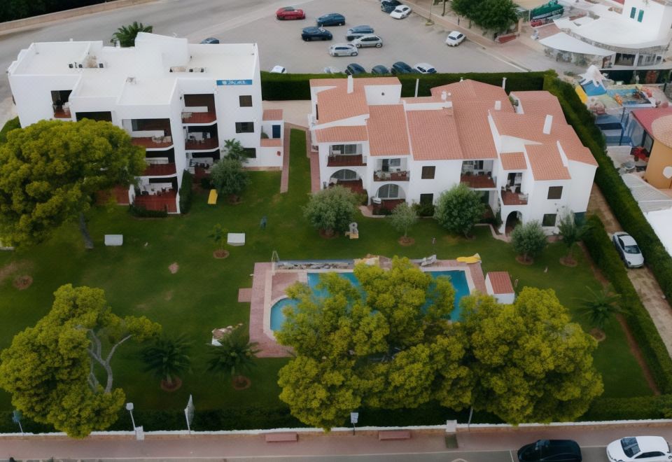 a bird 's eye view of a residential area with a pool surrounded by white buildings at Sol Y Mar
