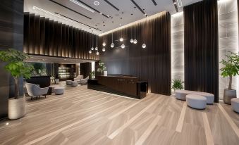 a modern hotel lobby with a large reception desk and several chairs arranged around it at Boston Hotel