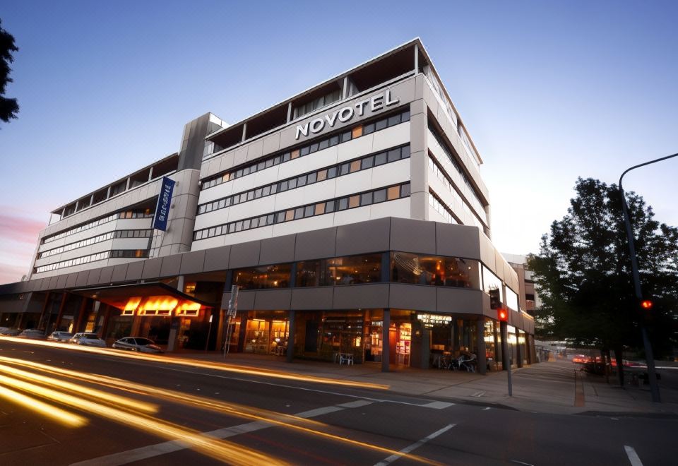 "a large , modern hotel building with a long awning and the name "" novotel "" on it" at Novotel Canberra