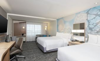 a hotel room with two beds , one on the left side and the other on the right side of the room at Courtyard Cleveland Elyria