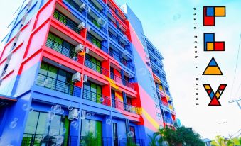 a colorful building with a rainbow effect on the side , located in a city setting at Play Phala Beach Rayong