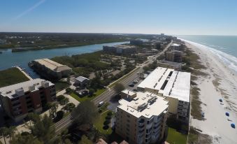 aerial view of a city near the ocean , featuring buildings and a road and beach at Legacy Vacation Resorts-Indian Shores