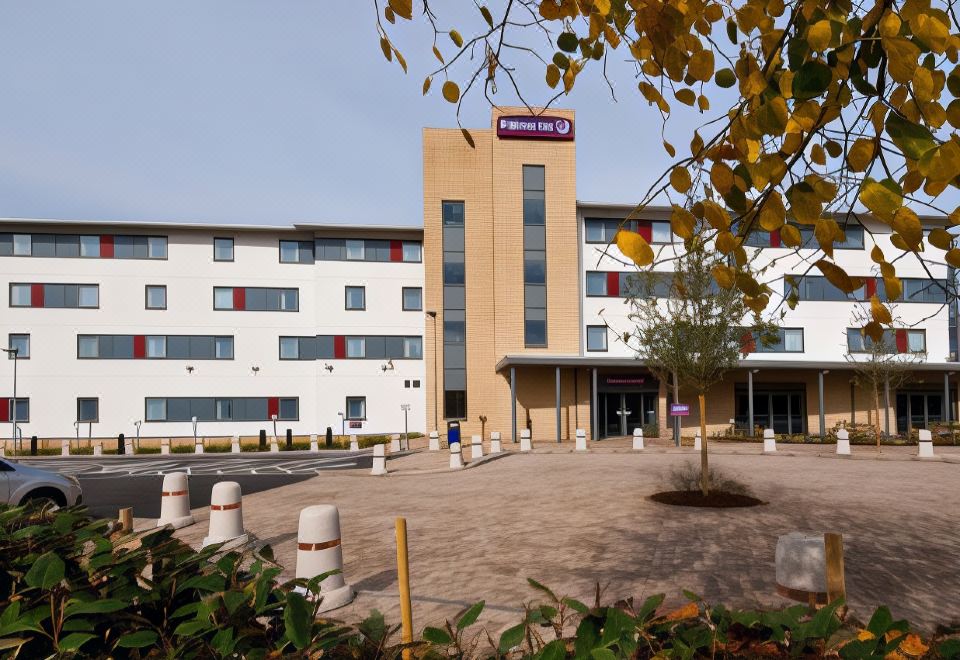 "a large hotel building with multiple stories and a red sign that reads "" premier inn "" is shown" at Premier Inn Rochester