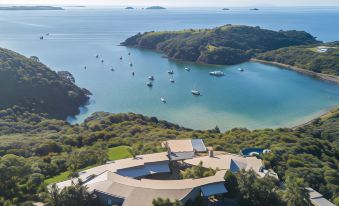 aerial view of a large house surrounded by water , with boats in the distance and other boats in the bay at Delamore Lodge