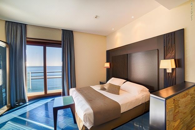 a hotel room with a large window overlooking the ocean , featuring a bed with a brown comforter and two nightstands at Hotel la Lucertola