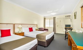 a hotel room with three beds , two of which are twin beds and one is a double bed at Bayswater Tweed