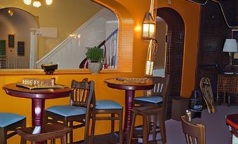 a cozy dining area with several chairs and tables , creating a warm and inviting atmosphere at Thayers Inn