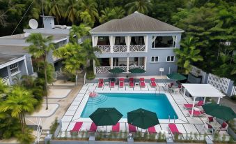 an aerial view of a resort with a swimming pool surrounded by chairs and umbrellas at The Palms Resort