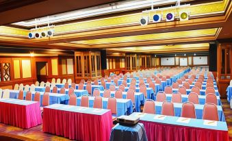 a large conference room with rows of tables and chairs , set up for an event at Asian Hotel