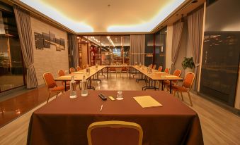 a large conference room with multiple tables and chairs arranged for a meeting or event at Hotel Diplomatic