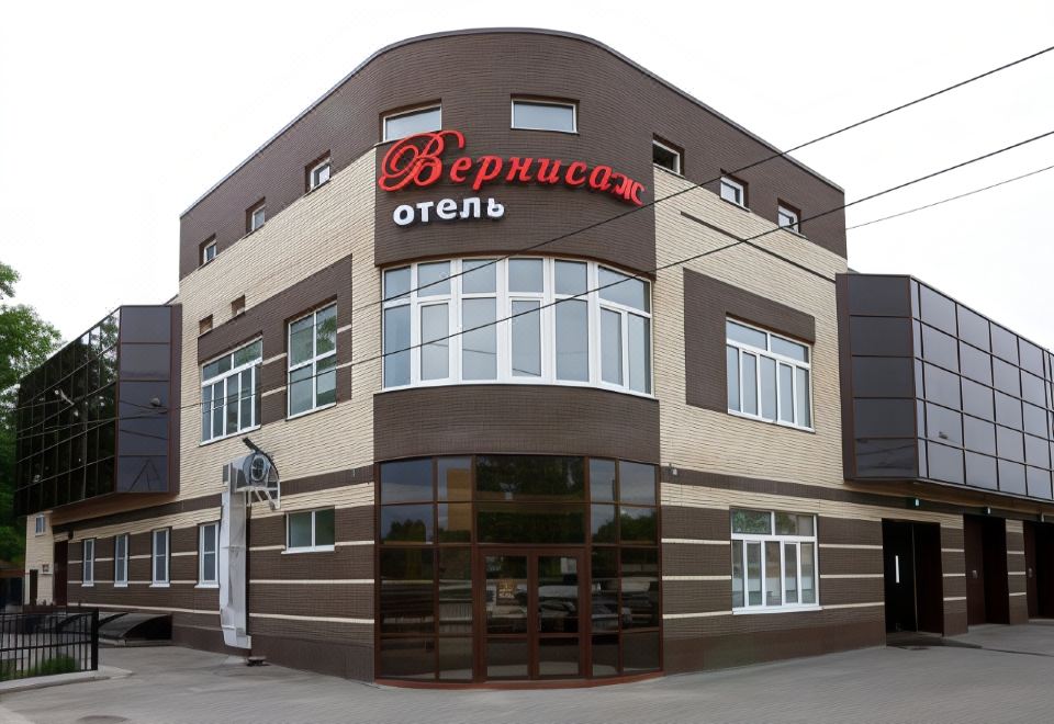 "a building with a sign that says "" bevector отех "" in red letters , surrounded by windows" at Vernisage