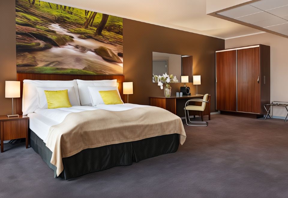 a luxurious hotel room with a large bed , a desk , and a painting on the wall at Quality Hotel Grand Kongsberg