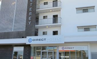 "a building with a sign that says "" direct hotels & apartments "" on the side of it" at Monterey Apartments Moranbah