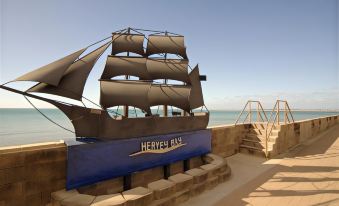 "a large wooden sculpture of a ship with the words "" hervey bay "" written on it" at Best Western Ambassador Motor Lodge