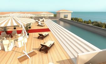 a rooftop deck with lounge chairs , umbrellas , and a swimming pool overlooking the ocean , creating a relaxing atmosphere at Toscana Charme Resort