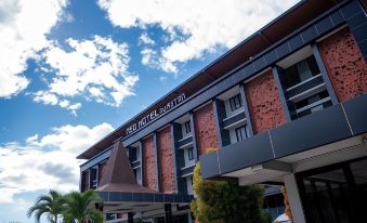 "a large red building with a brown roof and the words "" mimi hotel hotel "" on it" at Hotel Neo Eltari - Kupang by Aston