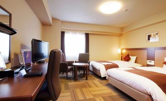 a modern hotel room with two beds , a desk , and a tv , all set against beige walls and wooden flooring at Daiwa Roynet Hotel Hachinohe
