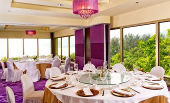 The room features large windows and tables set for four, including an elegant dining table at Grand Coloane Resort Macau