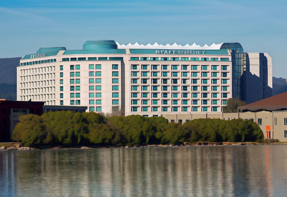 "a large hotel building with a green dome and the words "" intercontinental "" on it is reflected in the water" at Hyatt Regency San Francisco Airport