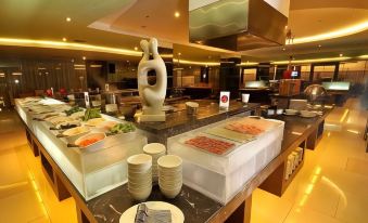 a buffet table with various food items and dishes , including a white figure on top at Golden Flower by Kagum Hotels