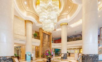 The large building features a lobby and main room adorned with chandeliers on both sides at Celebrity City Hotel