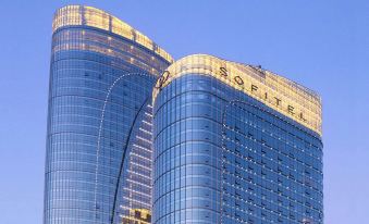 There is a large building with two towers on top and one in the middle, which is painted blue at Sofitel Guangzhou Sunrich