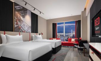 A modern bedroom with double beds, large windows, and a view of the outdoors at Radisson RED Hotel Zhuhai Gongbei Port