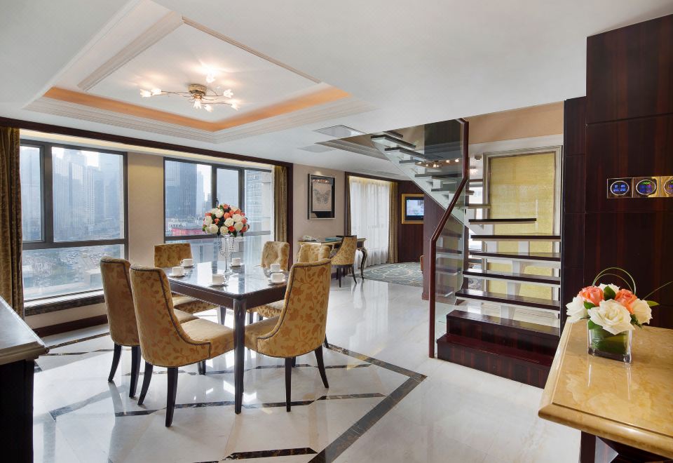 a spacious room furnished with modern decor and featuring an open concept kitchen and dining area at President Hotel (Guangzhou Tianhe Gangding Subway Station Store)