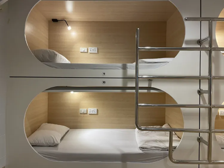 Bed In Budget Space Capsule With Shared Bathroom