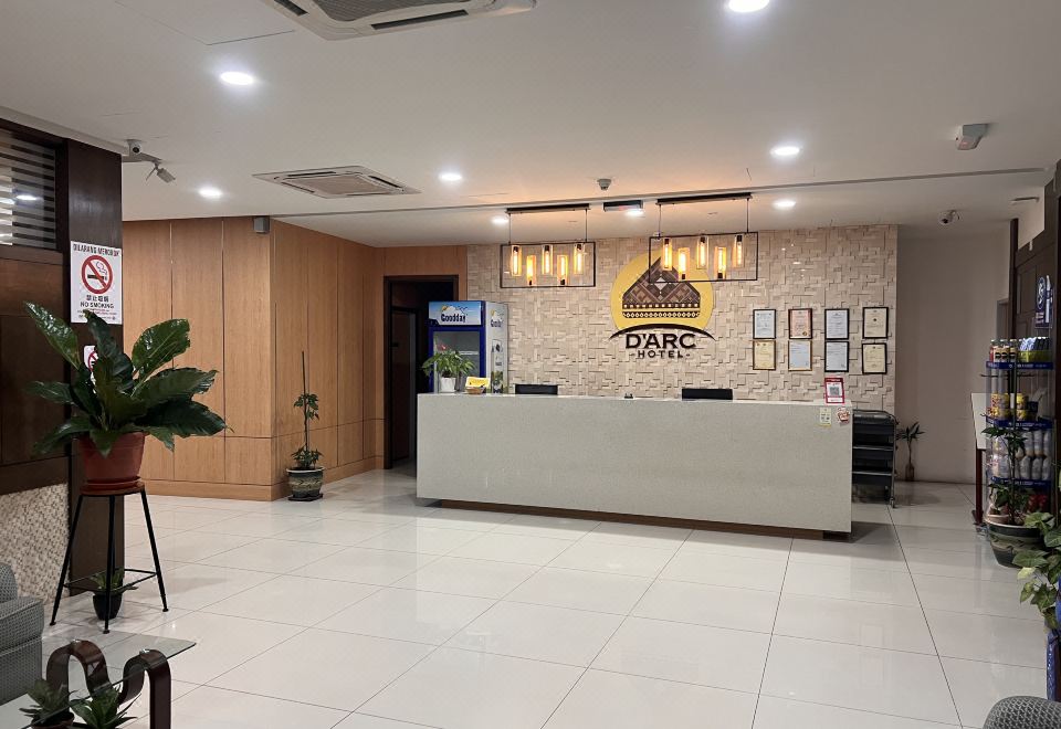 a modern office interior with white walls , wooden paneling , and a large window , featuring the logo of oabc and some plants at D Arc Hotel