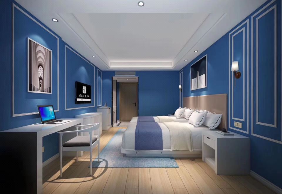 The room features a spacious white bed with walls adorned in a blue and brown color scheme at European Style Theme Smart Hotel (Yiwu International Trade City District 2 and 3)