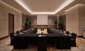 The hotel offers a spacious conference room equipped with long tables and black chairs, suitable for meetings and other business events at Grand Hyatt Beijing